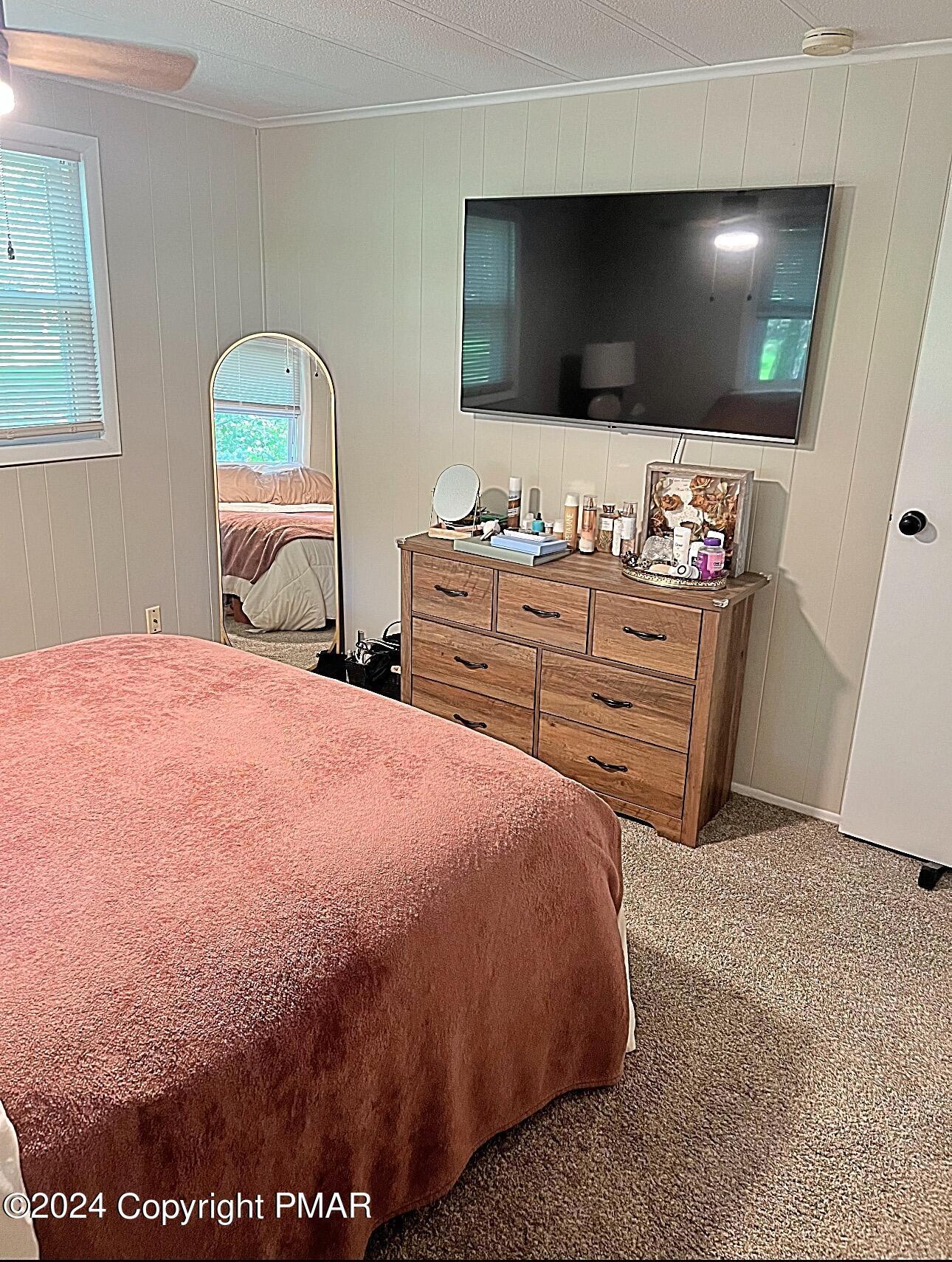93 Iroquois Road Albrightsville, PA 18210 - Photo 11 of 24 a bedroom with a bed and a flat screen tv