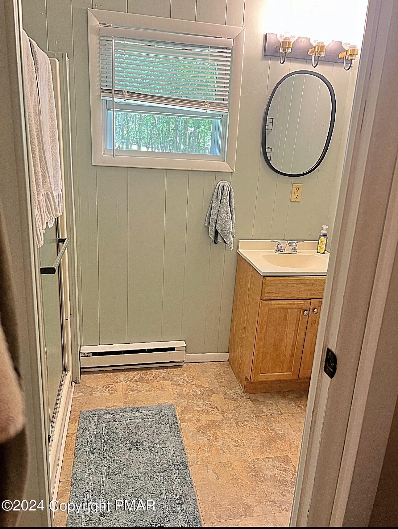93 Iroquois Road Albrightsville, PA 18210 - Photo 16 of 24 a bathroom with a sink a mirror and a window