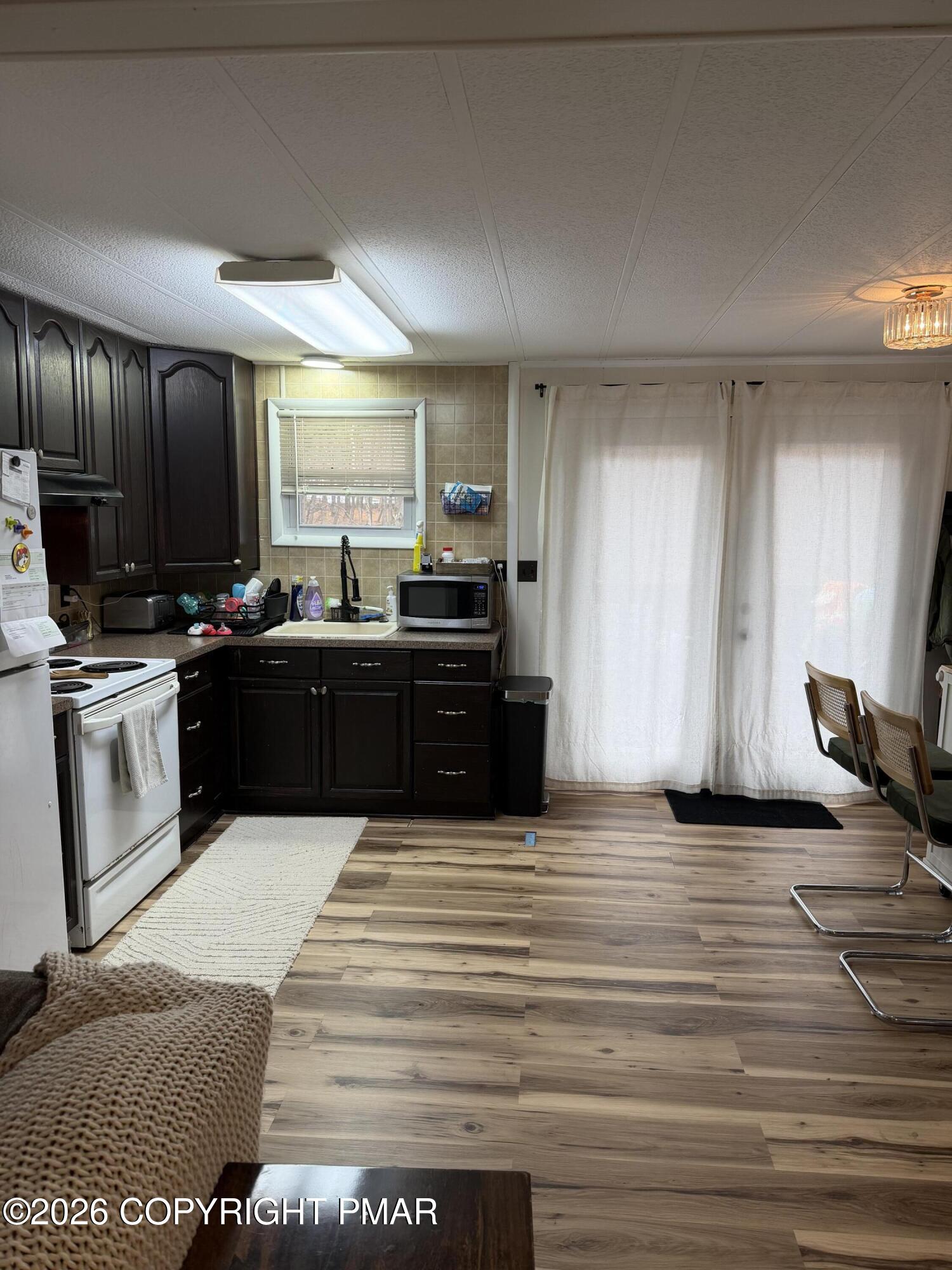 93 Iroquois Road Albrightsville, PA 18210 - Photo 22 of 24 a large kitchen with kitchen island granite countertop a sink and stainless steel appliances