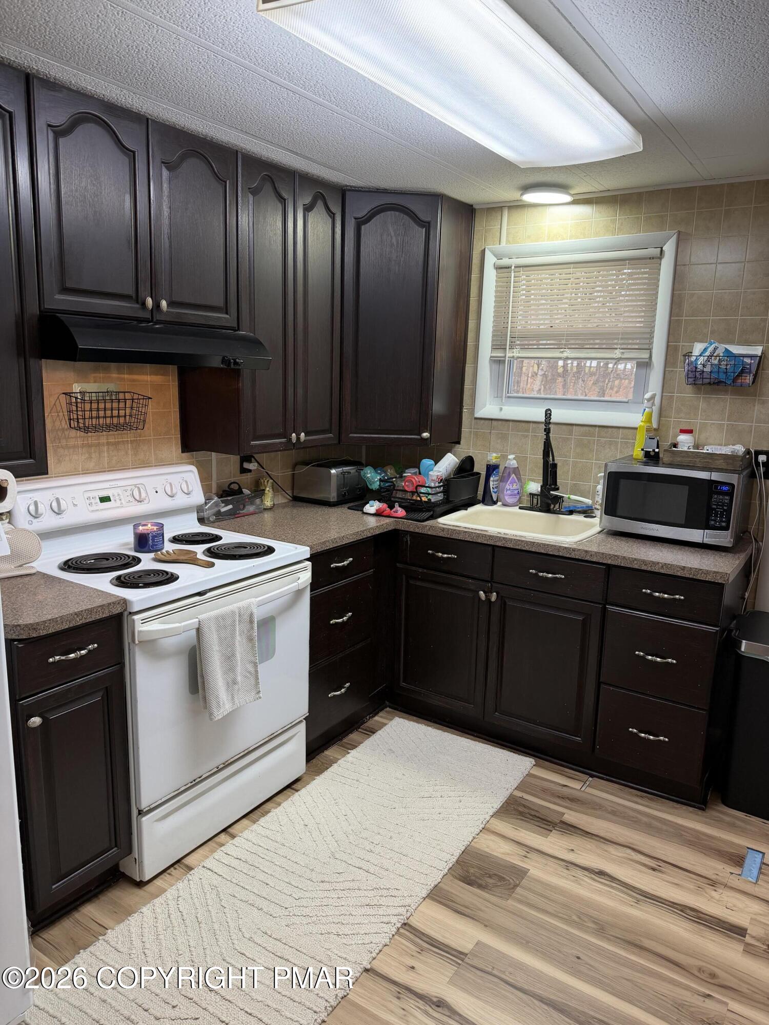 93 Iroquois Road Albrightsville, PA 18210 - Photo 4 of 24 a kitchen with a sink a stove and cabinets