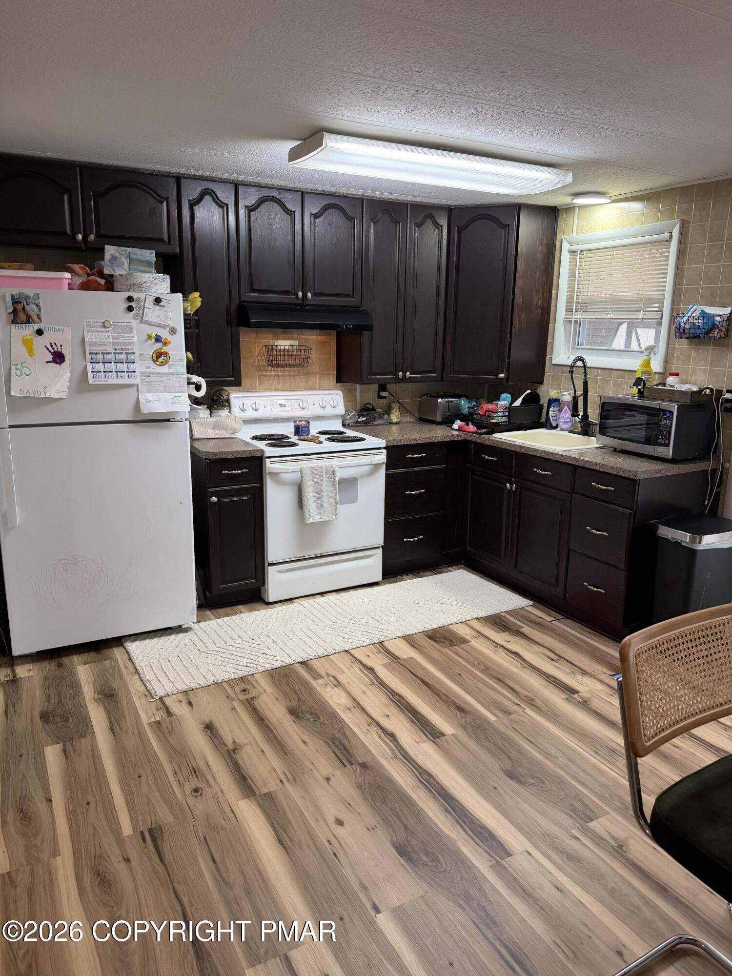 93 Iroquois Road Albrightsville, PA 18210 - Photo 7 of 24 a kitchen with stainless steel appliances granite countertop a stove a sink and a refrigerator