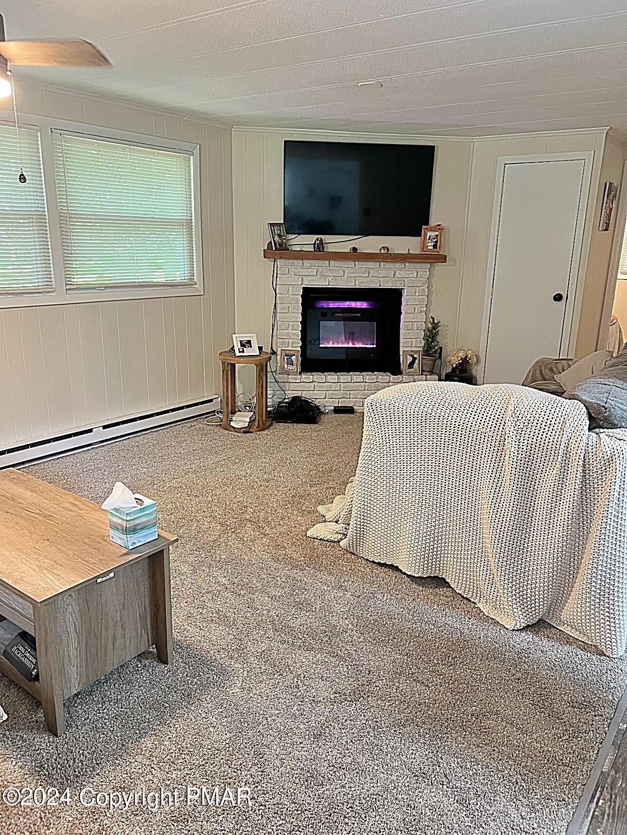 93 Iroquois Road Albrightsville, PA 18210 - Photo 9 of 24 a living room with furniture flat screen tv and a fireplace