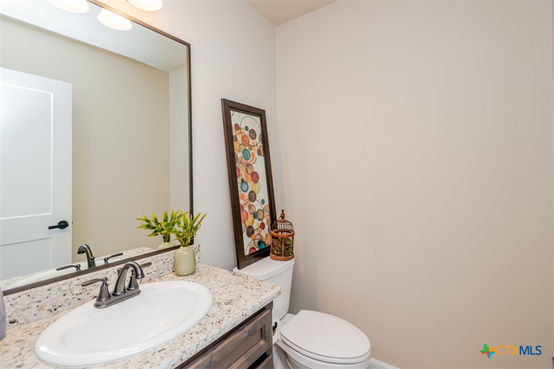 3497 Hooten Bend Kempner, TX 76539 - Photo 15 of 36 a bathroom with a granite countertop sink and a mirror with toilet