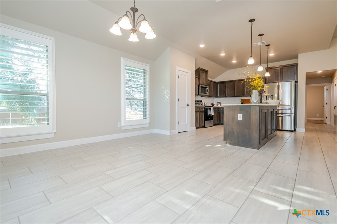 3497 Hooten Bend Kempner, TX 76539 - Photo 20 of 36 a kitchen with stainless steel appliances kitchen island granite countertop a refrigerator a stove top oven and a sink with granite countertops