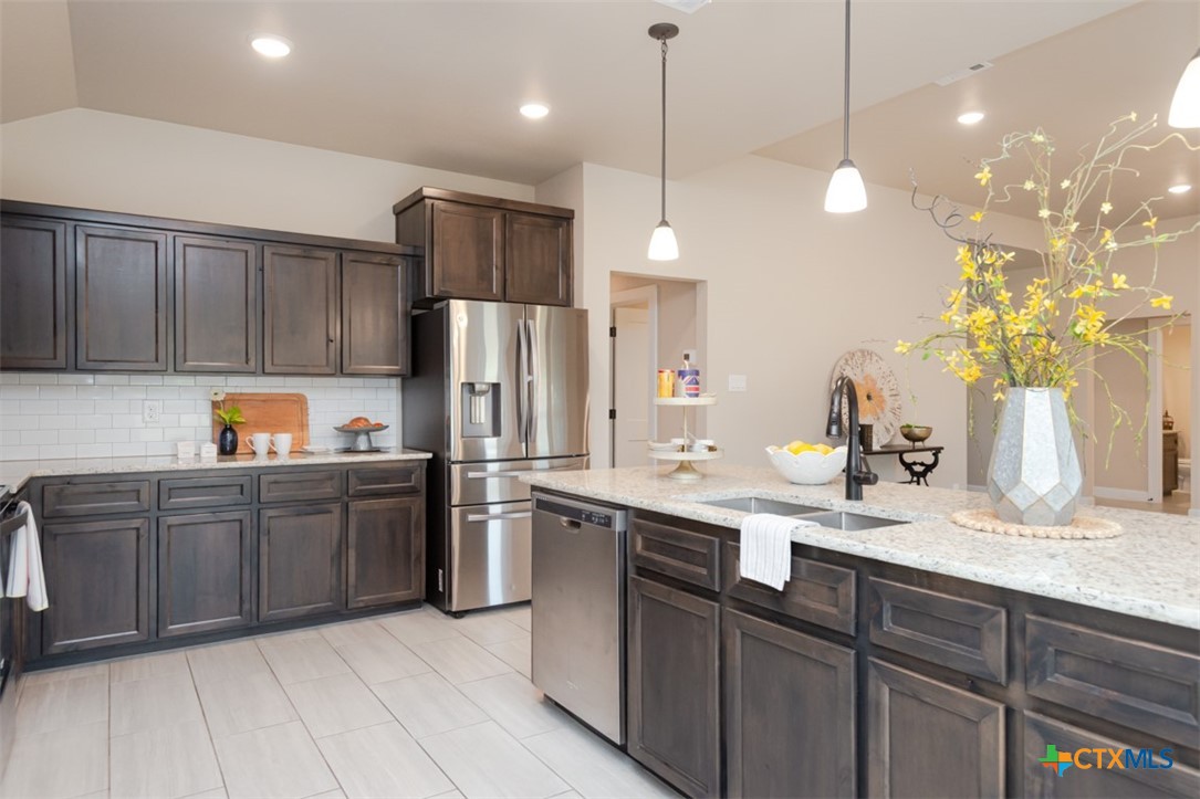 3497 Hooten Bend Kempner, TX 76539 - Photo 2 of 36 a kitchen with stainless steel appliances granite countertop a sink a stove and a refrigerator