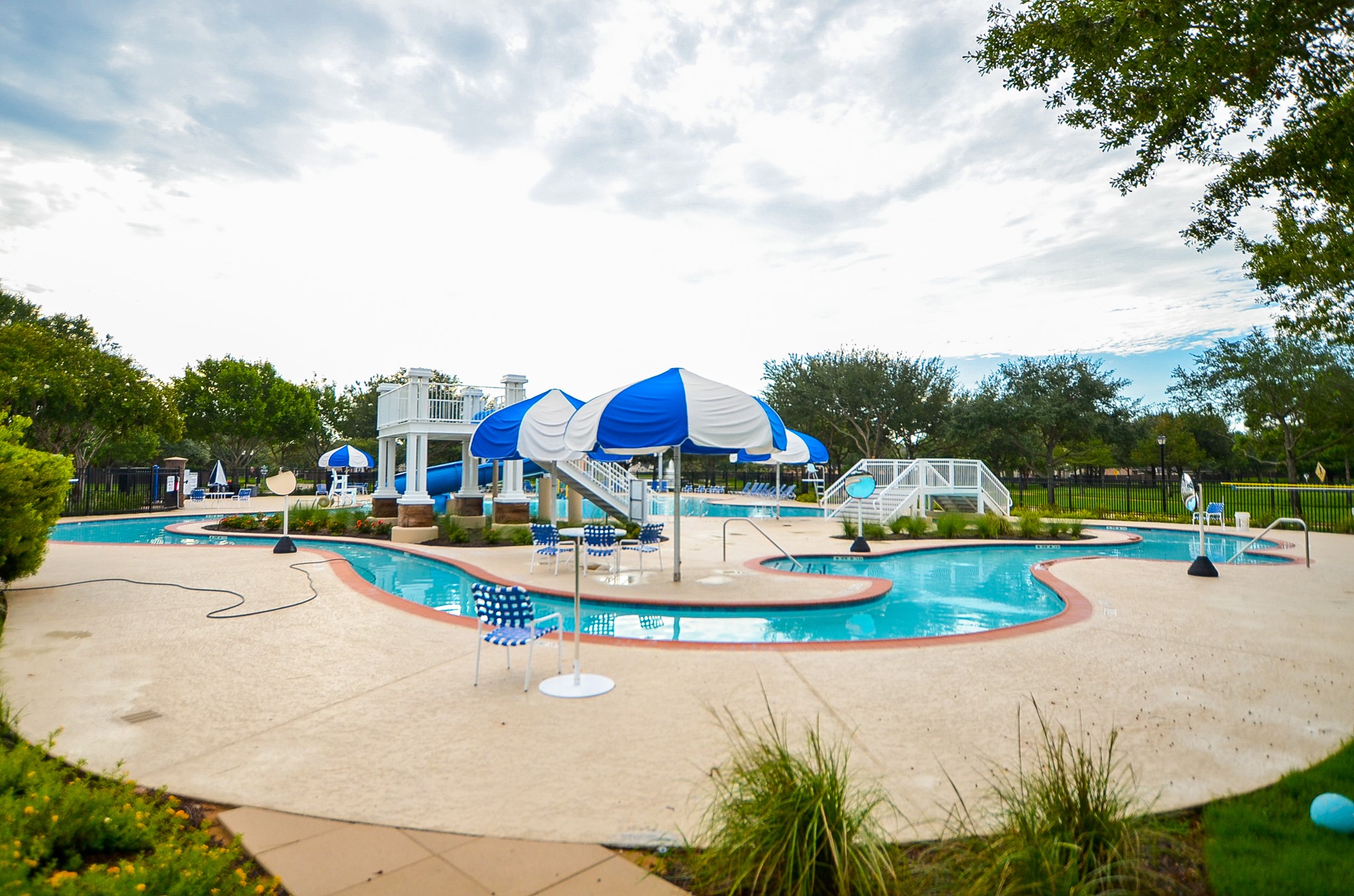7218 Spring Run Lane Katy, TX 77494 - Photo 45 of 49 a view of a swimming pool with lawn chairs and a big yard