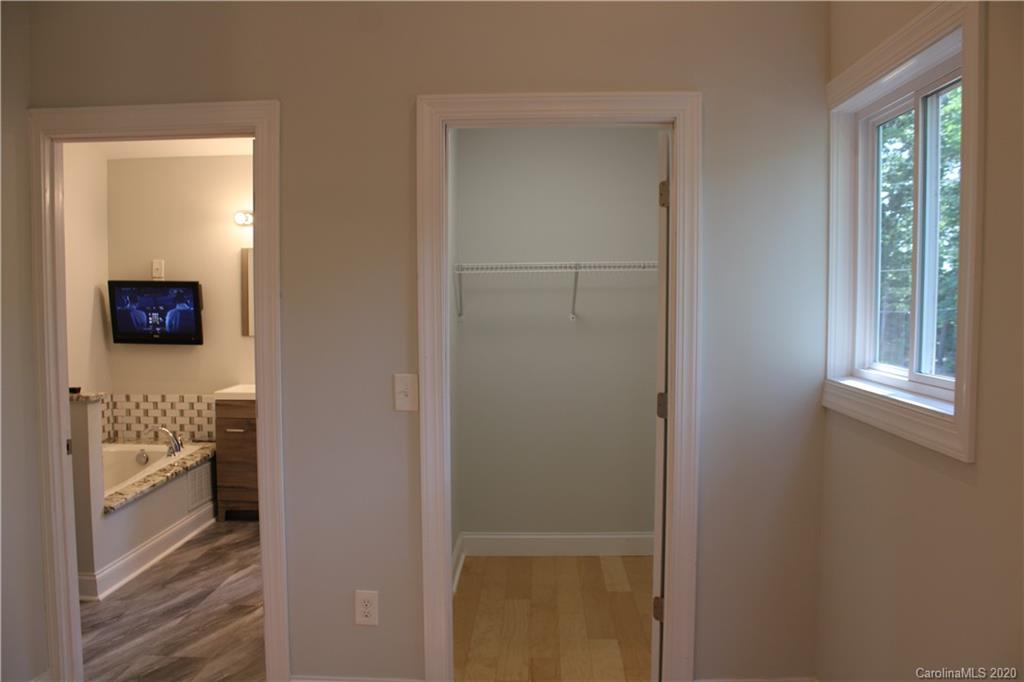 7716 Red Robin Trail Denver, NC 28037 - Photo 20 of 29 a view of a hallway with wooden floor and a bathroom