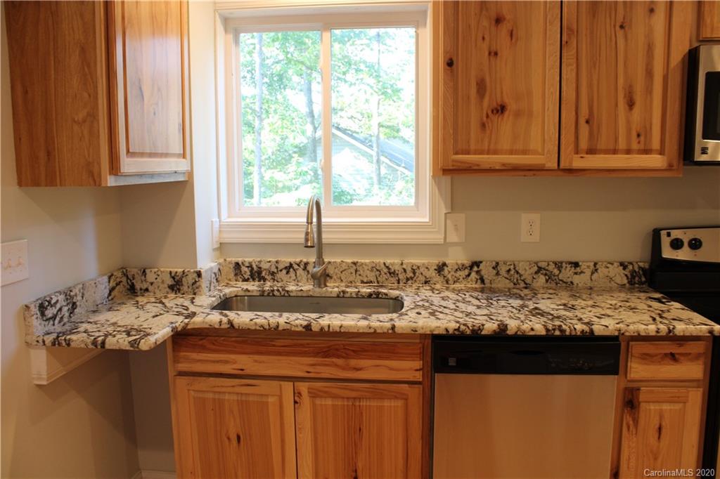 7716 Red Robin Trail Denver, NC 28037 - Photo 24 of 29 a kitchen with a sink a stove and window