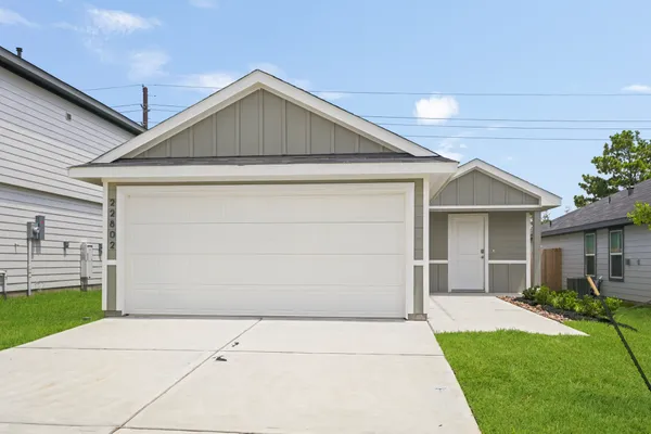 a front view of house with garage and yard