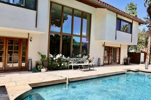 a view of a house with backyard porch and sitting area