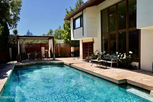 a view of a house with backyard porch and sitting area