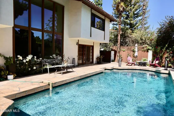 a view of a swimming pool with outdoor seating