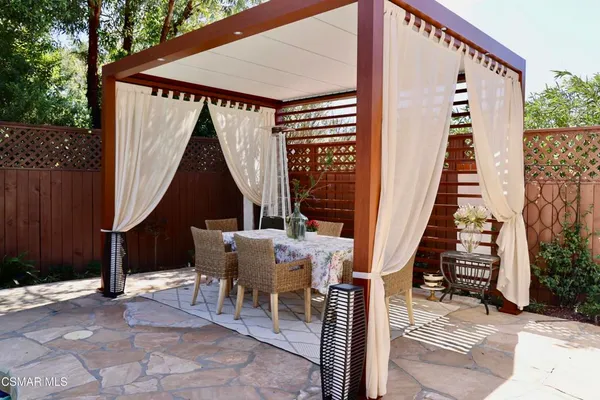 a view of deck with table and chairs