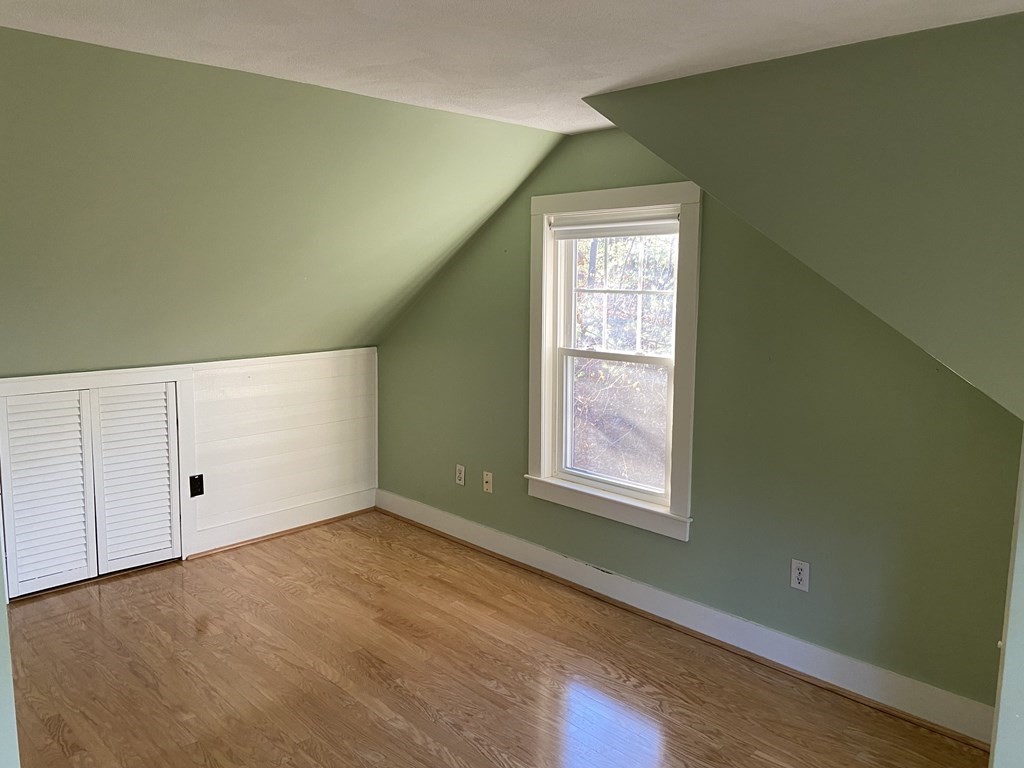 751 Central Avenue Needham, MA 02494 - Photo 11 of 21 a view of an empty room with wooden floor and a window