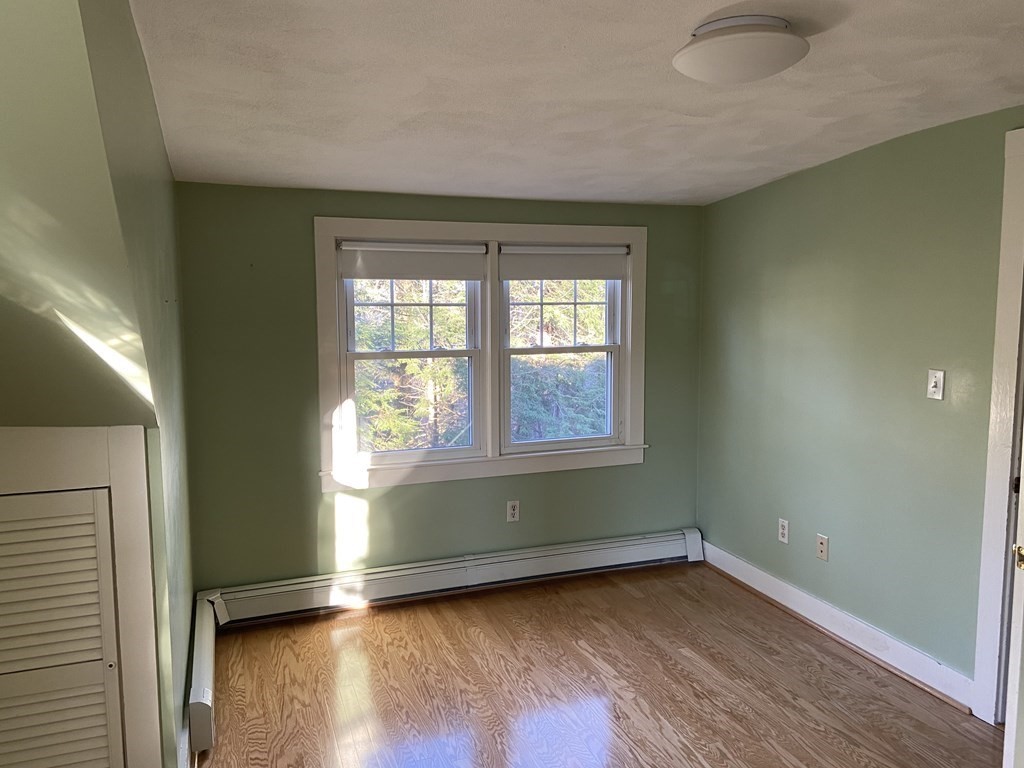 751 Central Avenue Needham, MA 02494 - Photo 12 of 21 an empty room with wooden floor and windows