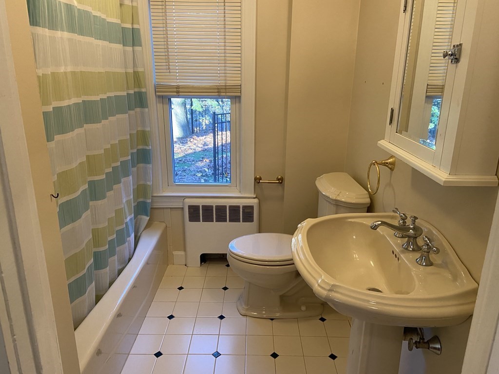 751 Central Avenue Needham, MA 02494 - Photo 13 of 21 a bathroom with a sink a toilet and shower