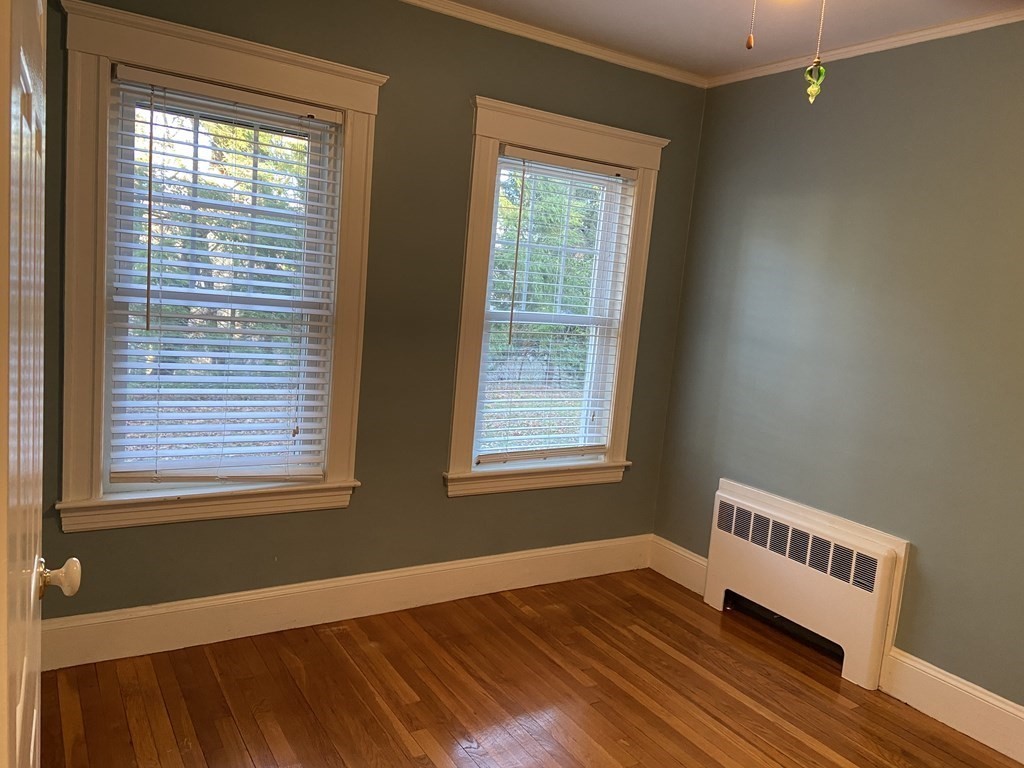 751 Central Avenue Needham, MA 02494 - Photo 17 of 21 a view of an empty room with wooden floor and a window