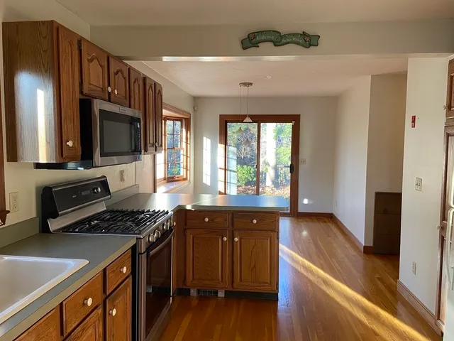 a kitchen with stainless steel appliances granite countertop a stove and a sink