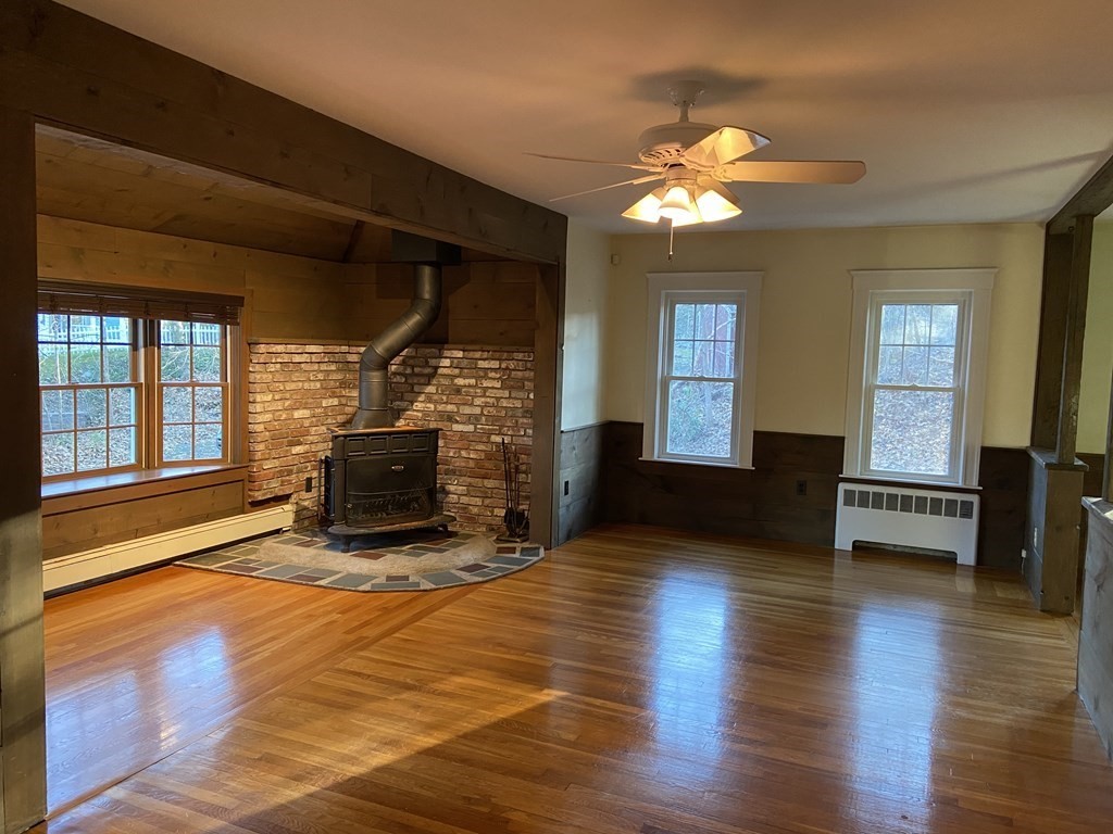 751 Central Avenue Needham, MA 02494 - Photo 8 of 21 a living room with furniture a fireplace and a flat screen tv