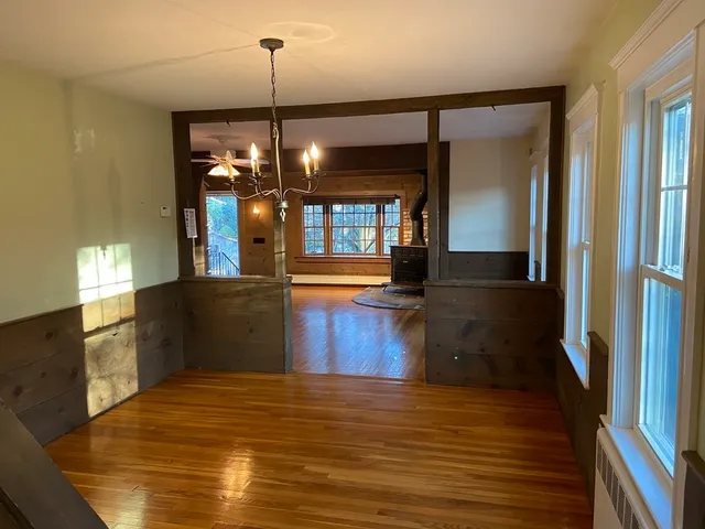 a kitchen area with granite countertop sink and refrigerator