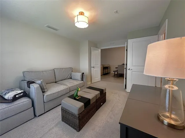 a living room with furniture and a lamp