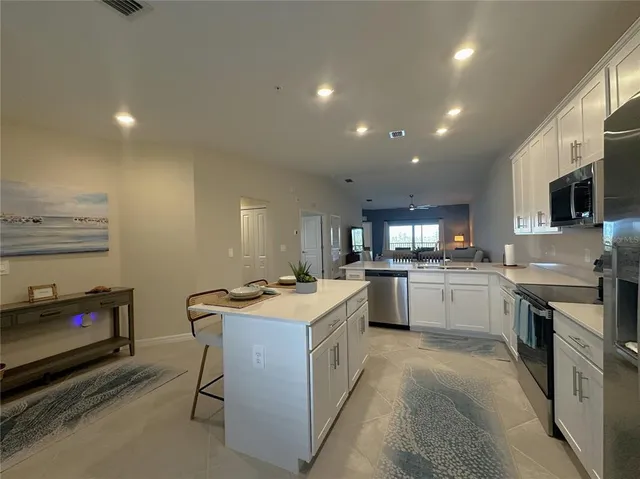 a kitchen that has a lot of cabinets in it and appliances