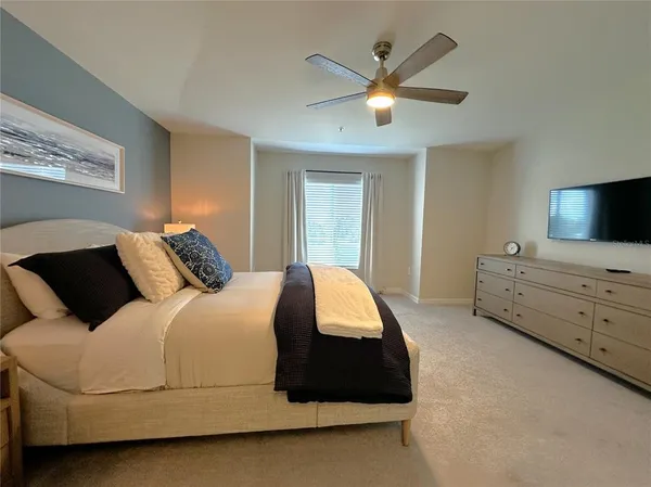 a bedroom with a bed and a tv