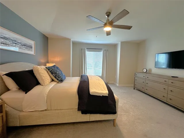 a bedroom with a bed and a tv