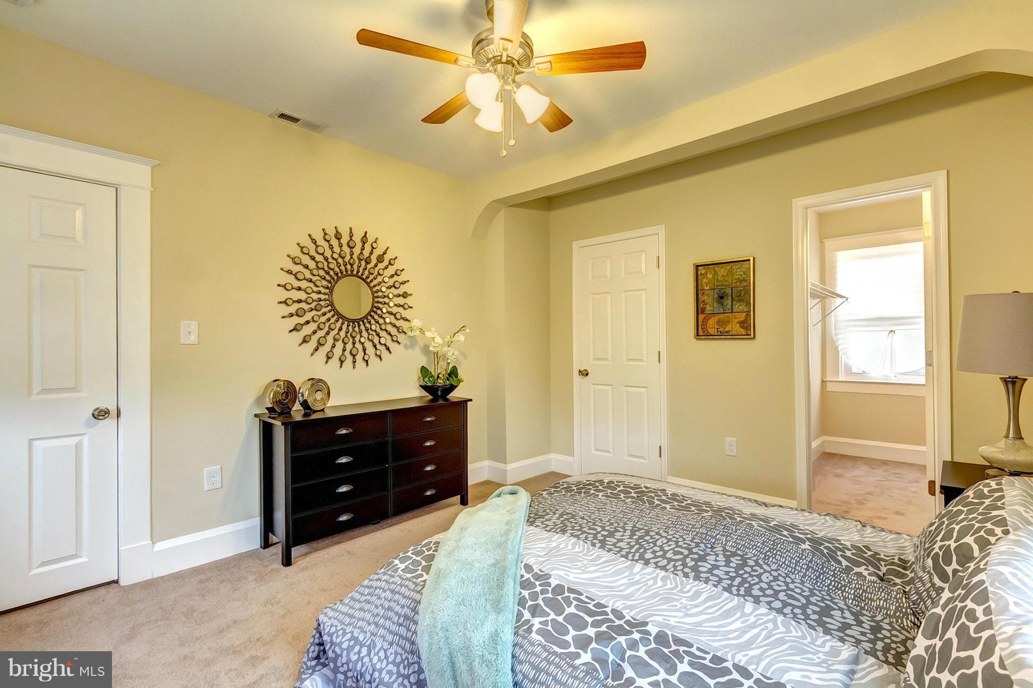 5800 Clearspring Road Baltimore, MD 21212 - Photo 20 of 30 a bedroom with a bed and a chandelier