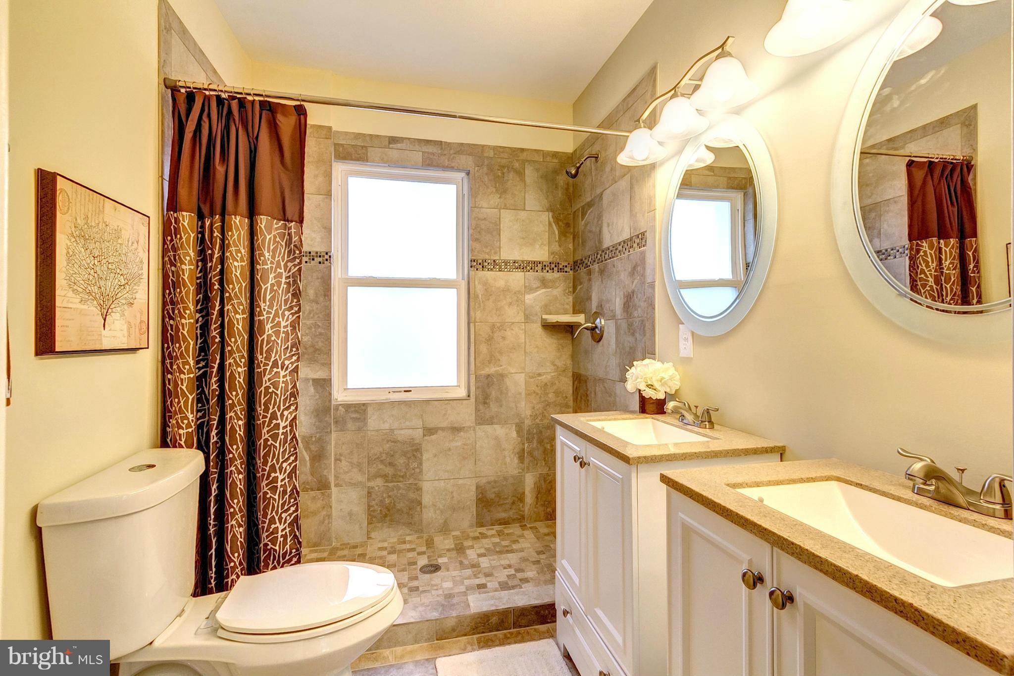 5800 Clearspring Road Baltimore, MD 21212 - Photo 21 of 30 a bathroom with a granite countertop sink mirror vanity and toilet