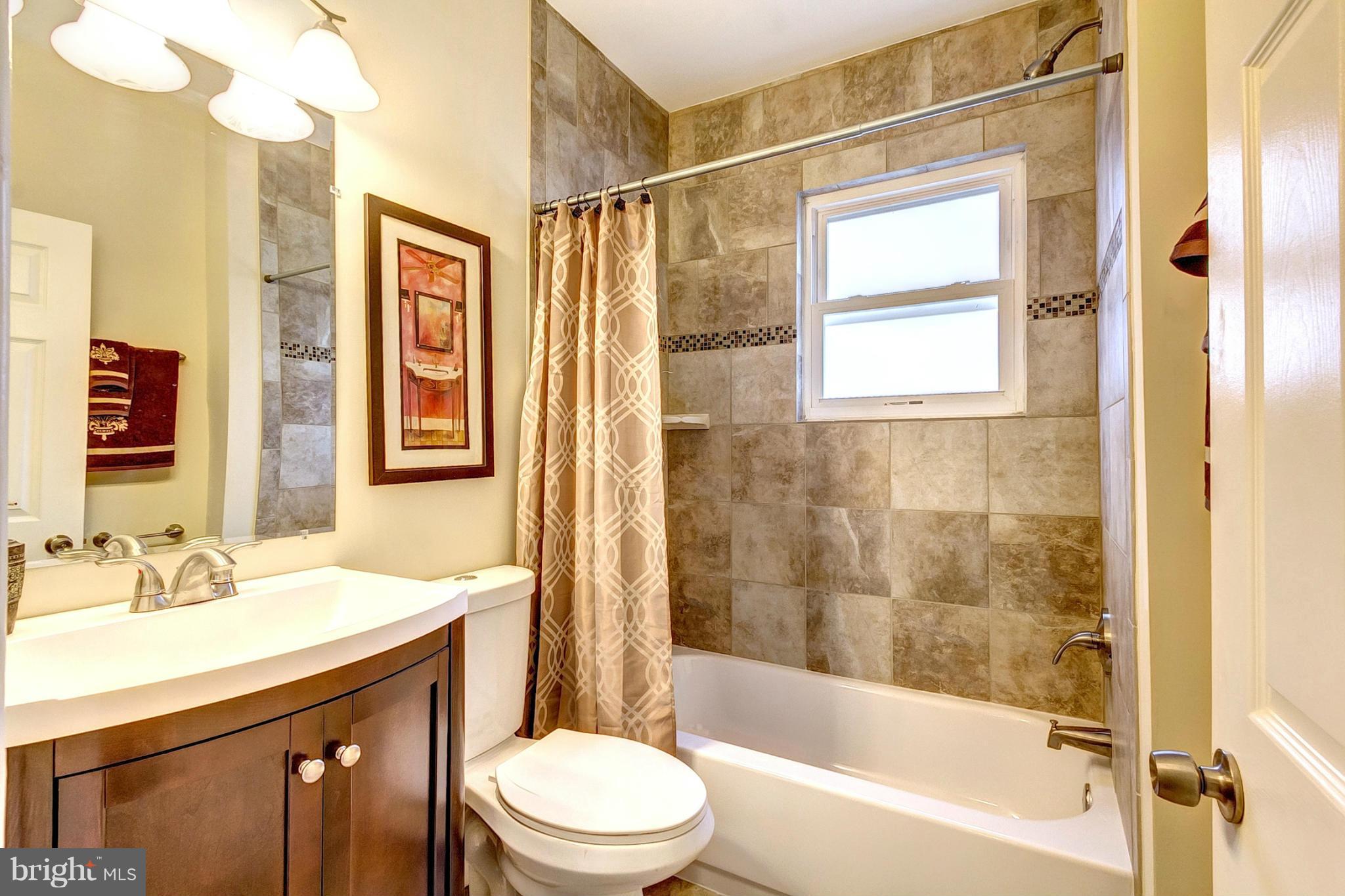 5800 Clearspring Road Baltimore, MD 21212 - Photo 23 of 30 a bathroom with a granite countertop sink toilet and shower