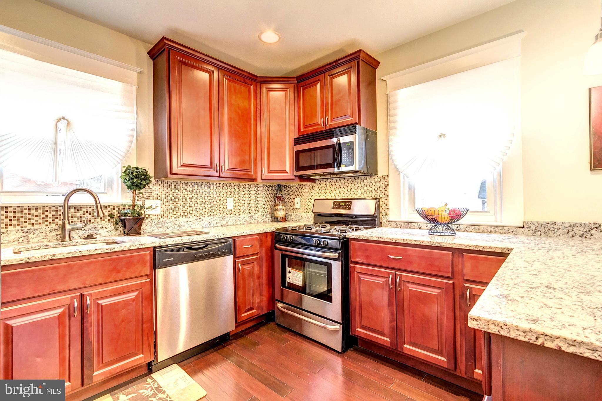 5800 Clearspring Road Baltimore, MD 21212 - Photo 9 of 30 a kitchen with stainless steel appliances granite countertop a stove top oven