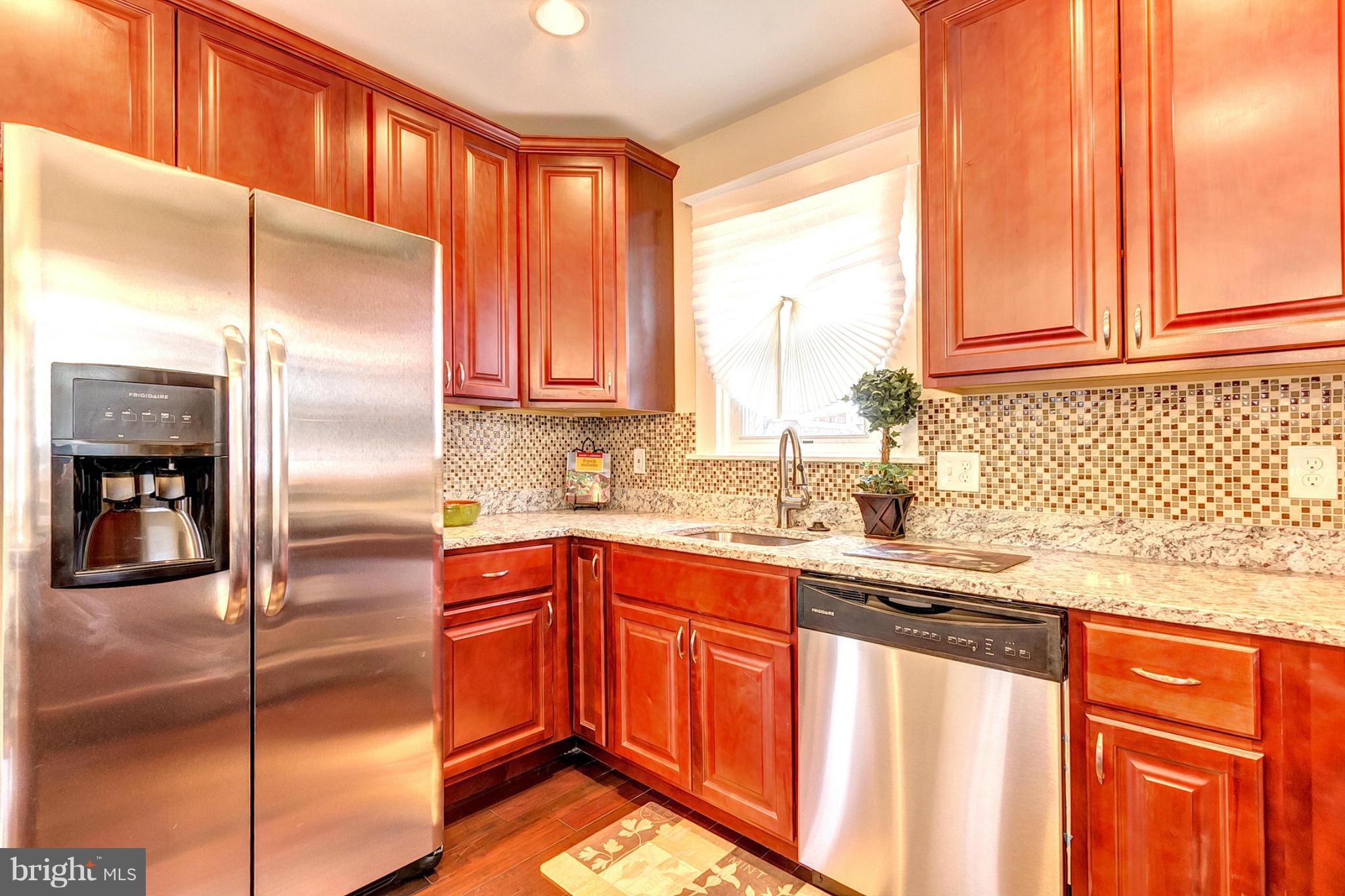 5800 Clearspring Road Baltimore, MD 21212 - Photo 10 of 30 a kitchen with stainless steel appliances granite countertop a refrigerator and a sink