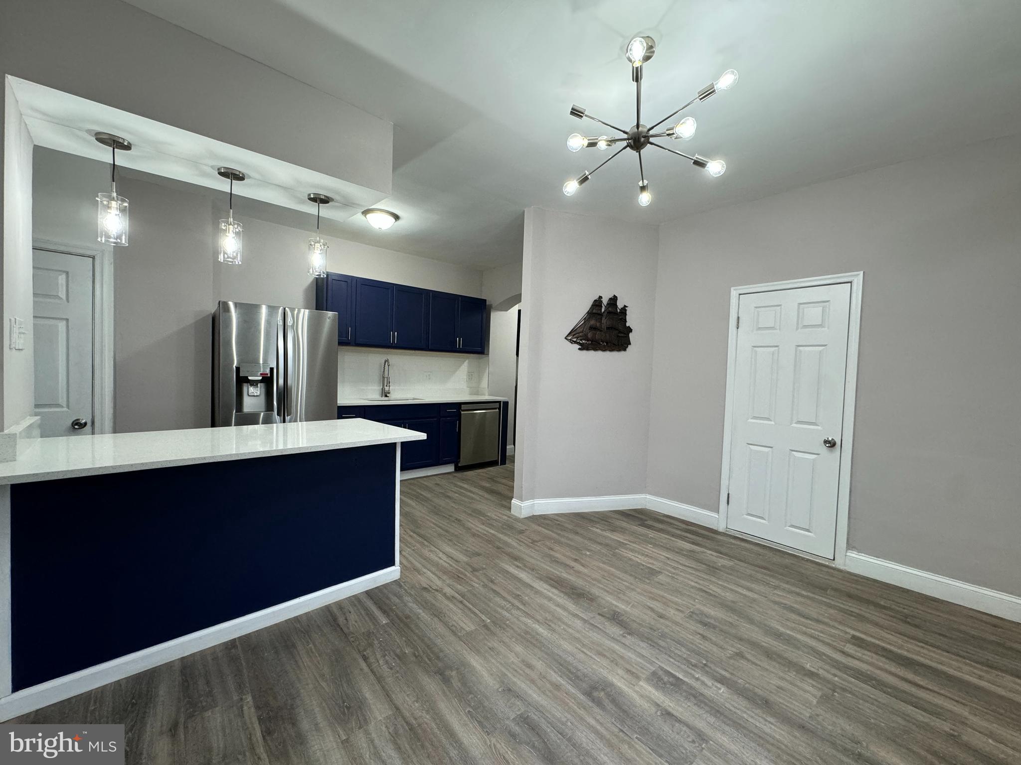 a view of kitchen with cabinets and wooden floor