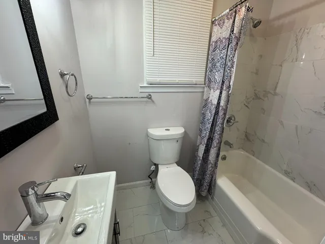 a bathroom with a toilet and a bathtub