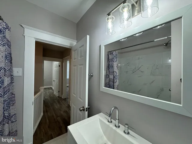 a bathroom with a sink and mirror