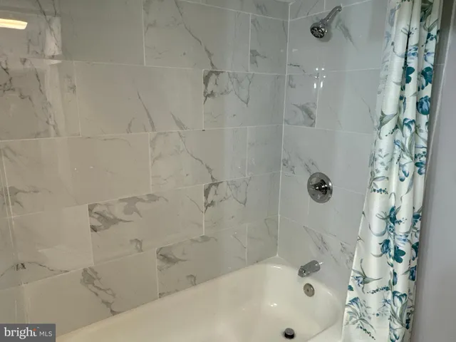 a bathroom with a bathtub and shower