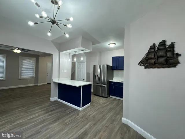 a view of a big room with wooden floor and cabinet