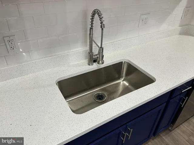 a close view of a sink and washing machine