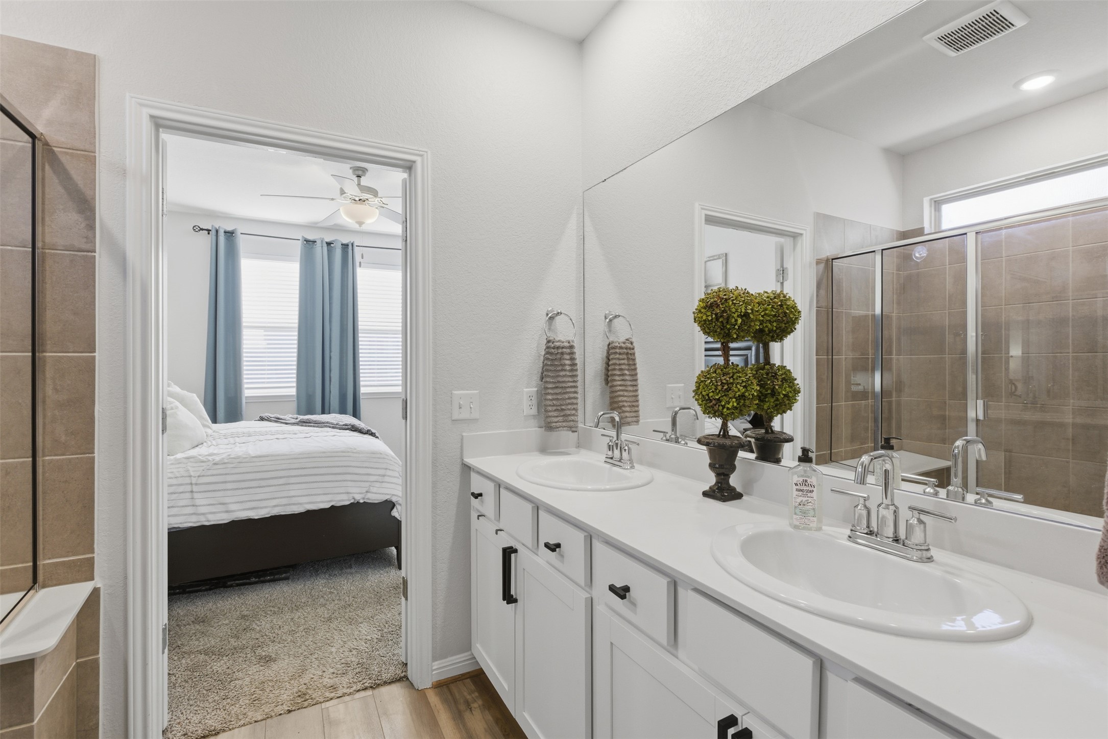 431 Dipprey Lane Georgetown, TX 78628 - Photo 25 of 39 a en suite bathroom with a double vanity sink and a mirror
