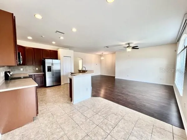 a kitchen with stainless steel appliances granite countertop a refrigerator a stove top oven a sink and dishwasher