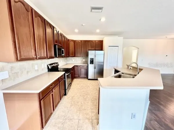 a view of a kitchen with a sink cabinets and wooden floor