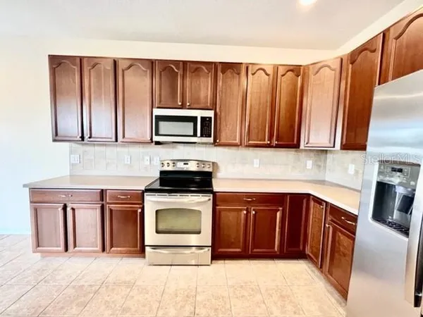 a view of a kitchen with a sink and a wooden floor