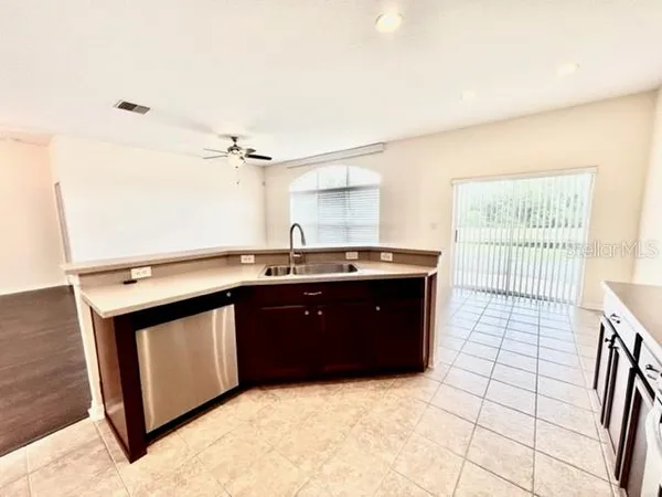 a view of a kitchen with a sink and a refrigerator
