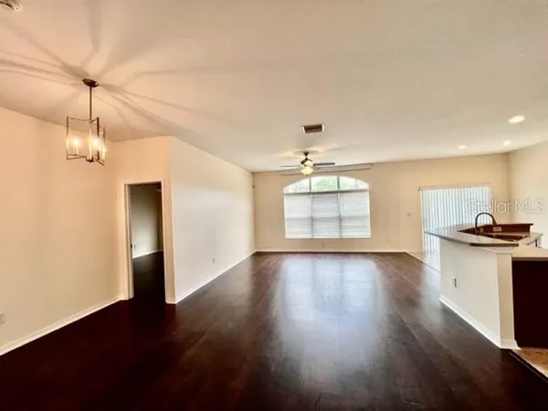 a bathroom with a granite countertop sink toilet a mirror and bathtub