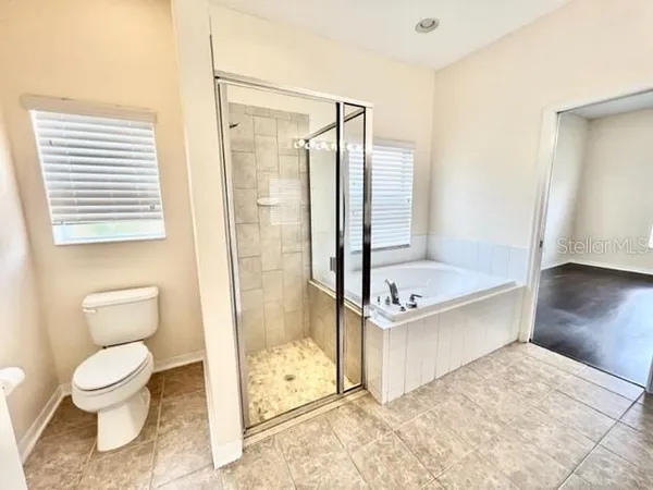 front view of a house with yard and large trees