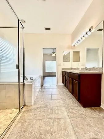 a view of a yard in front of a house with large trees