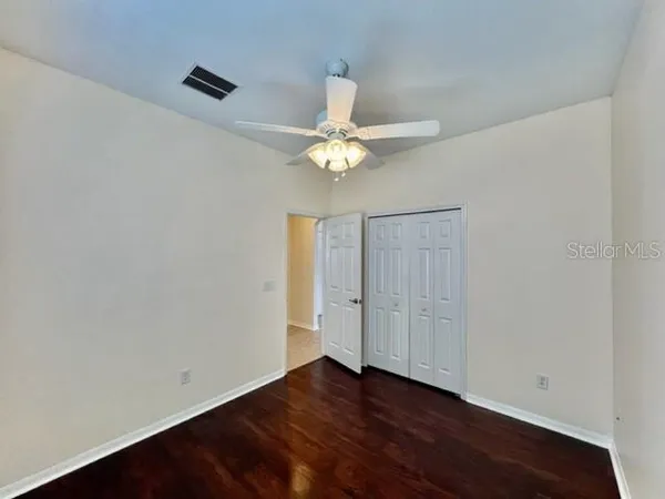 a view of a dining room with furniture a chandelier and wooden floor