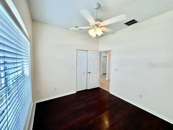 a living room with furniture a flat screen tv and a window