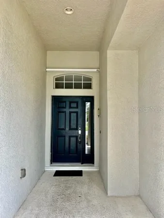 a view of kitchen with stainless steel appliances wooden floor and chair